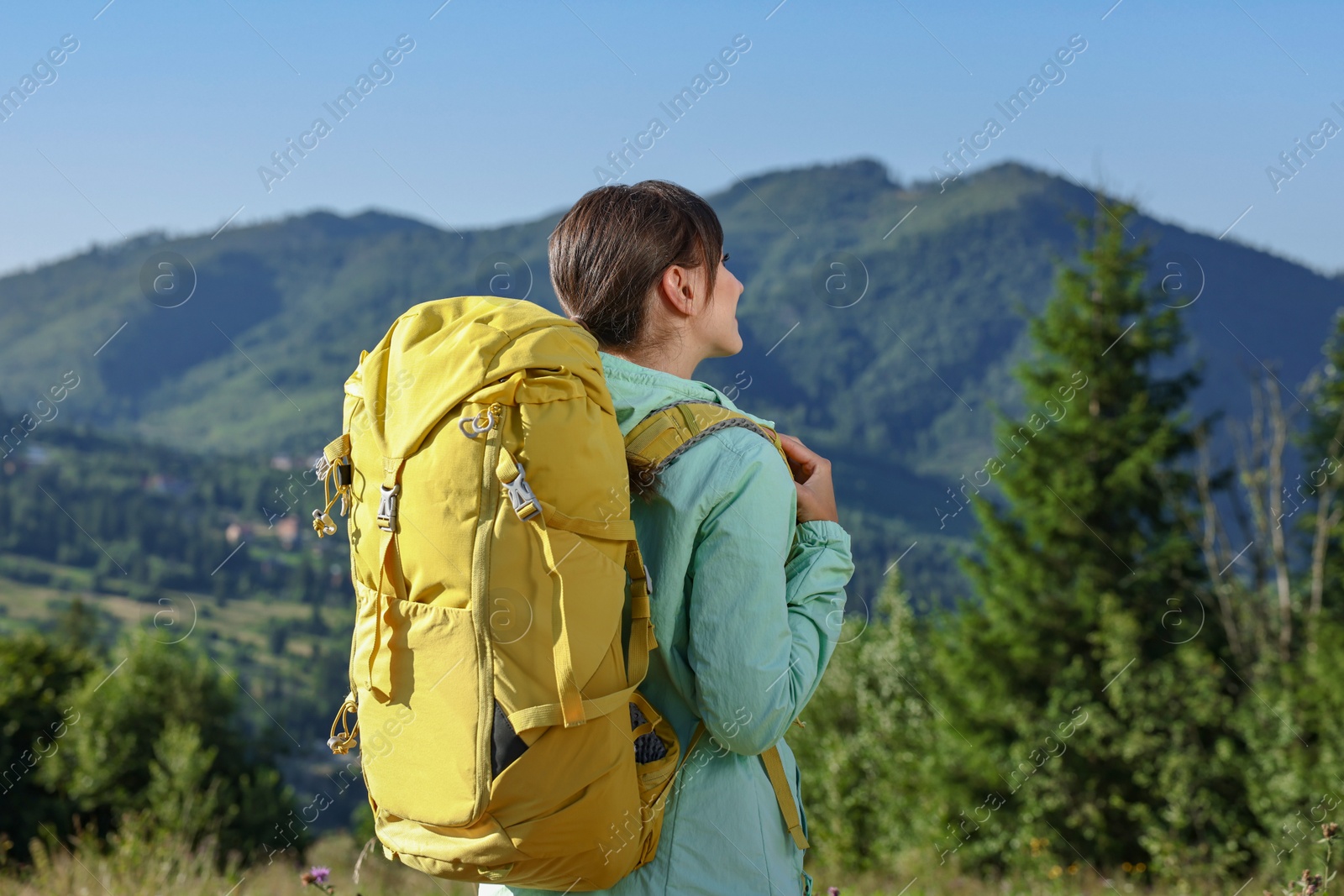 Photo of Young woman with backpack in beautiful mountains