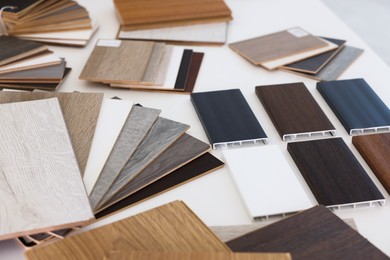 Photo of Different samples of wooden flooring on white table