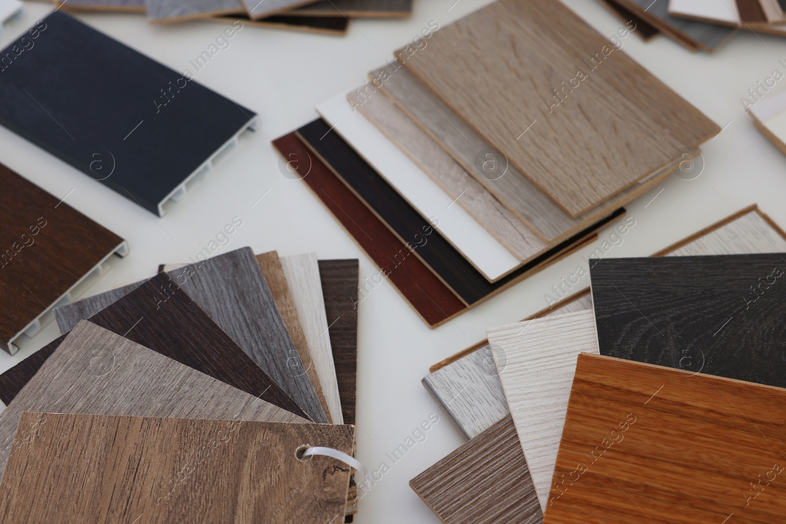 Photo of Different samples of wooden flooring on white table