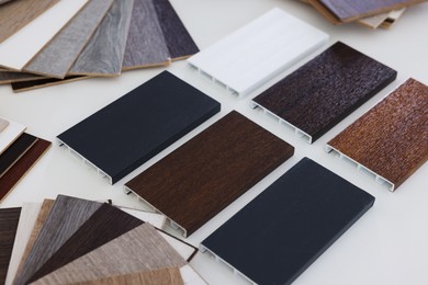 Photo of Different samples of wooden flooring on white table