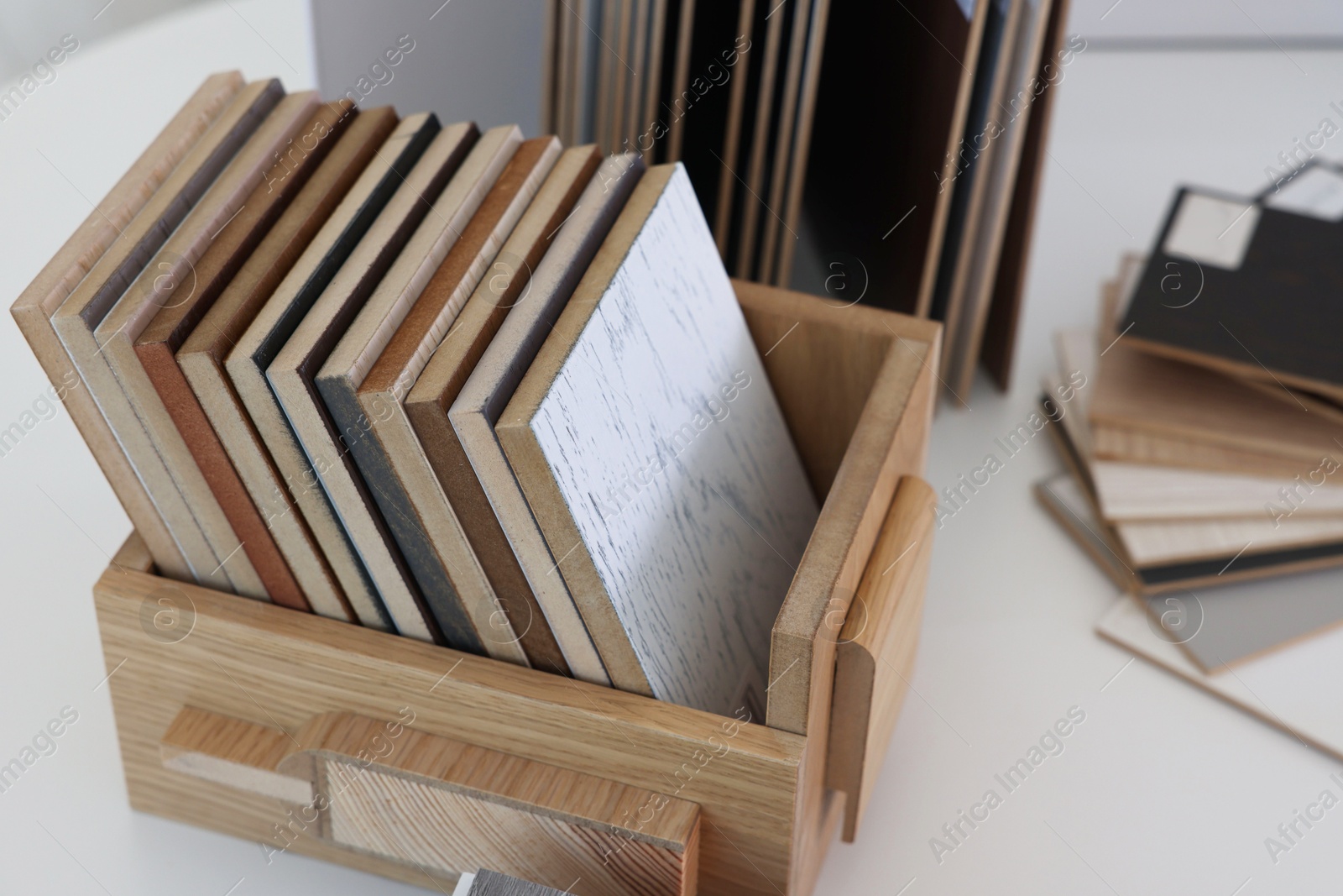 Photo of Different samples of wooden flooring on white table