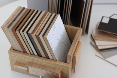 Photo of Different samples of wooden flooring on white table