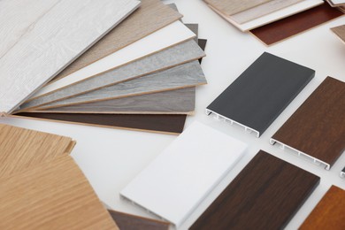 Photo of Different samples of wooden flooring on white table