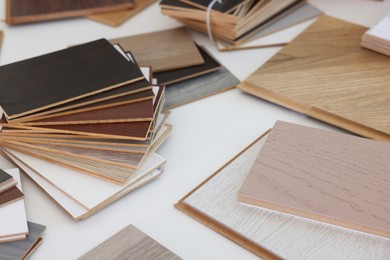 Photo of Different samples of wooden flooring on white table