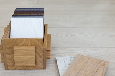 Photo of Different samples of wooden flooring in crate indoors