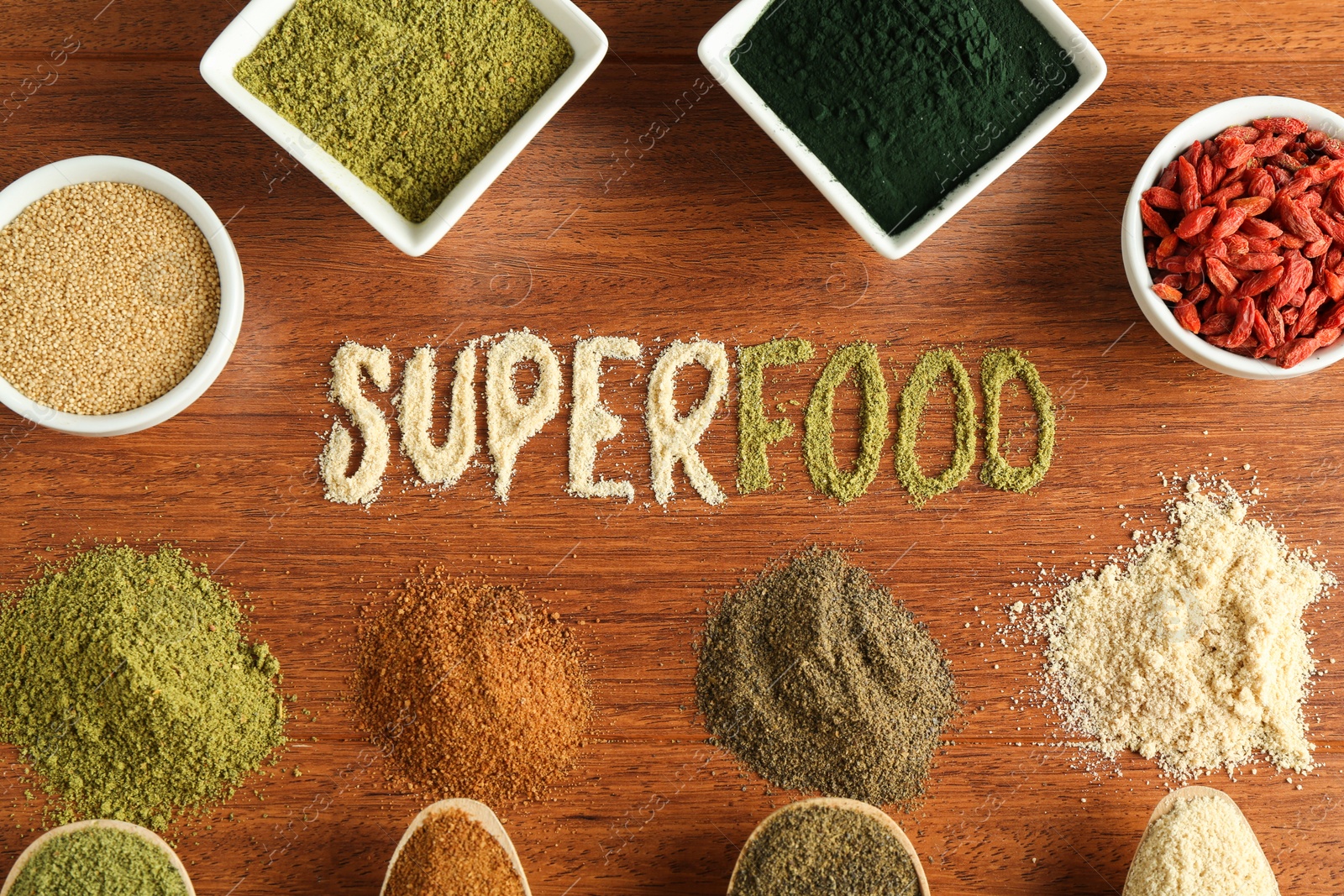 Photo of Word Superfood and different healthy powders on wooden table, flat lay