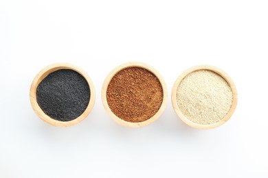 Photo of Different superfood powders in bowls on white background, flat lay