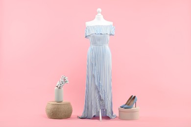 Photo of Mannequin with stylish dress and shoes on pink background