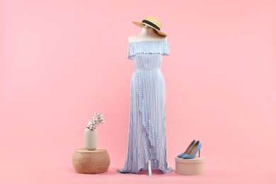 Photo of Mannequin with stylish dress, hat and shoes on pink background