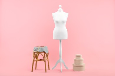 Photo of Mannequin, measuring tape and stool on pink background