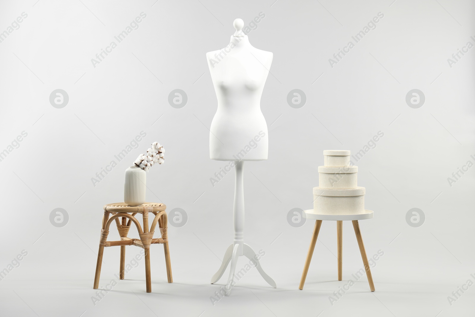 Photo of Mannequin, vase and stools on light grey background