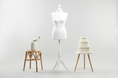 Photo of Mannequin, vase and stools on light grey background