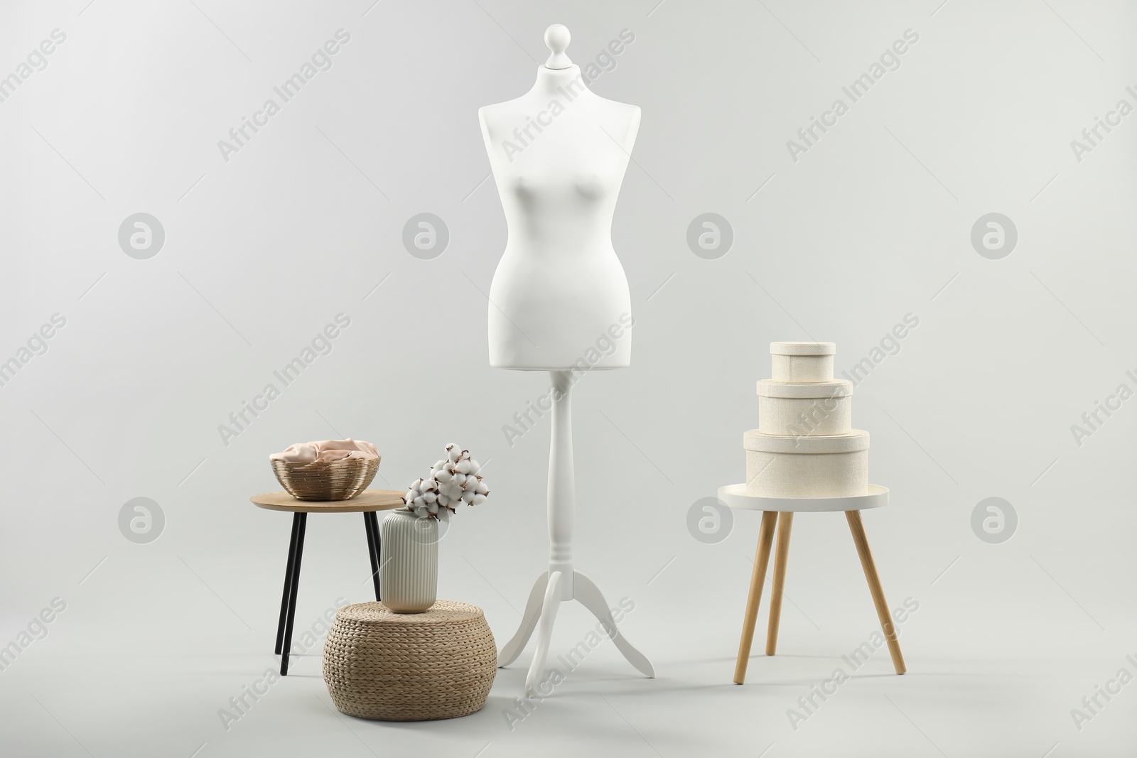 Photo of Mannequin and stools on light grey background