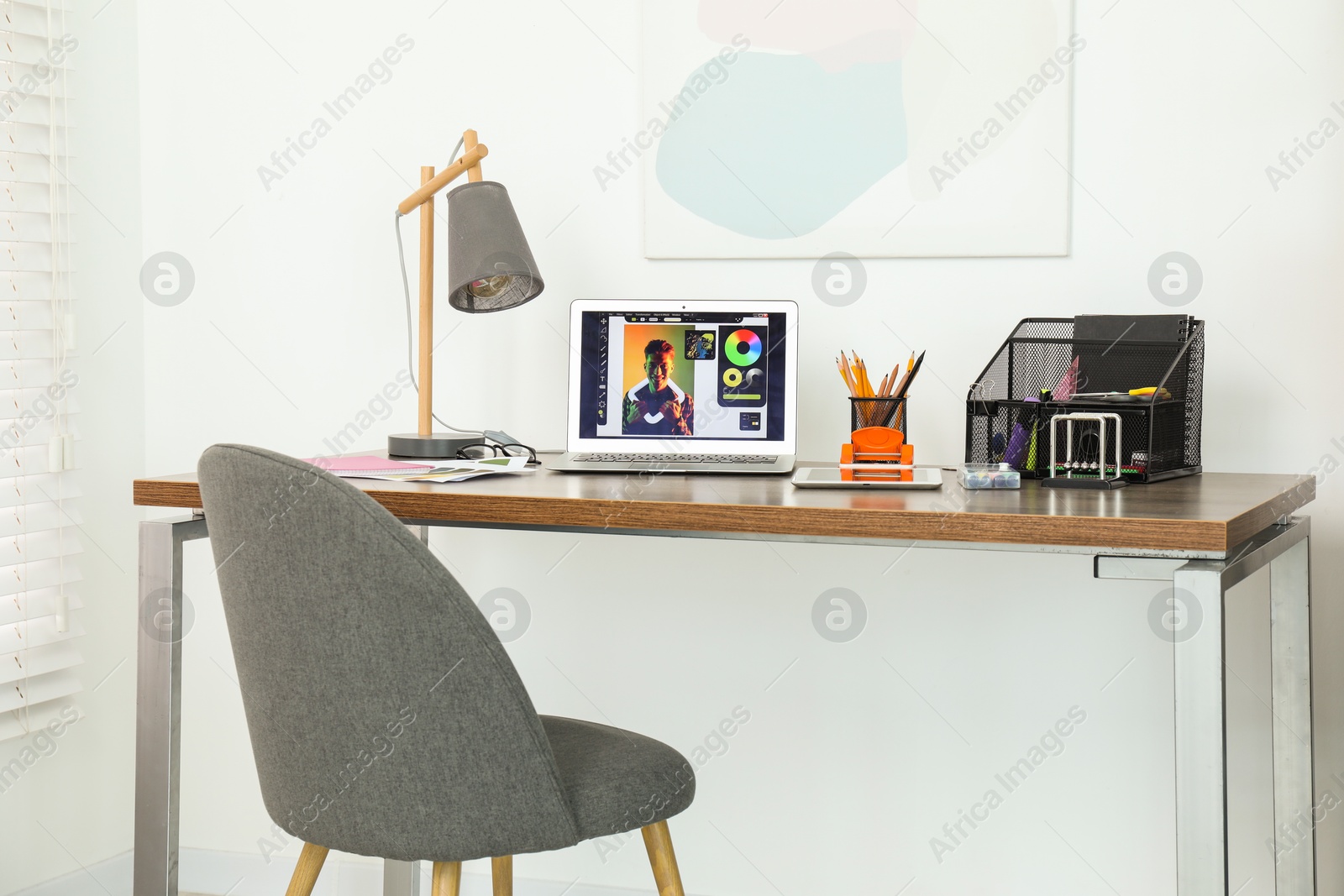 Photo of Fashion designer`s workplace with laptop and different supplies on table