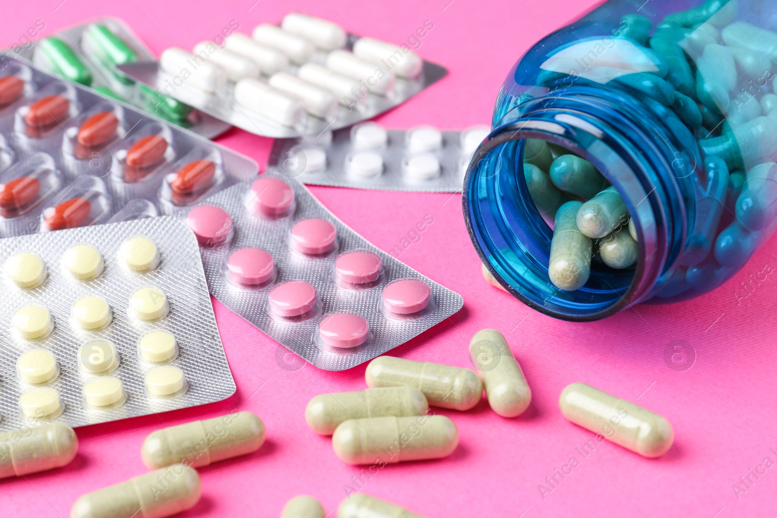 Photo of Pharmacist concept. Many different pills on pink background, closeup