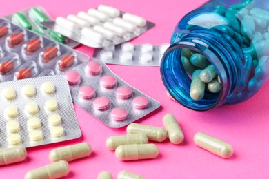 Photo of Pharmacist concept. Many different pills on pink background, closeup