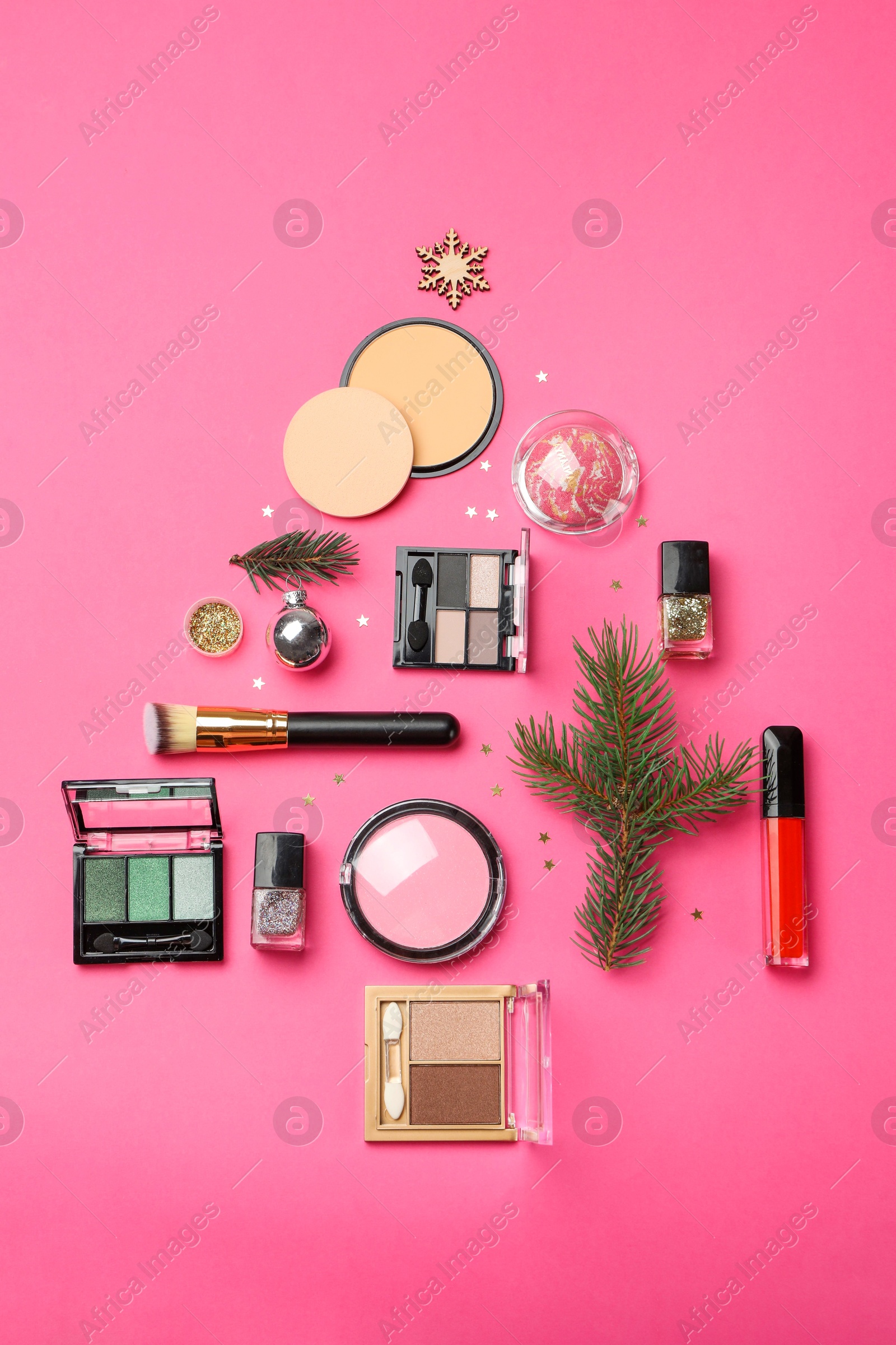 Photo of Flat lay composition with makeup products and Christmas decor on pink background