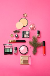 Photo of Flat lay composition with makeup products and Christmas decor on pink background