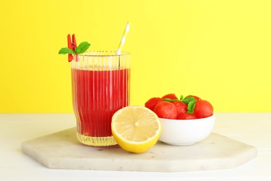 Photo of Tasty watermelon drink in glass and fresh fruits on white table