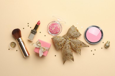 Photo of Flat lay composition with makeup products and Christmas decor on beige background