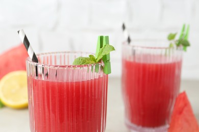 Photo of Delicious watermelon drink in glasses on table, closeup