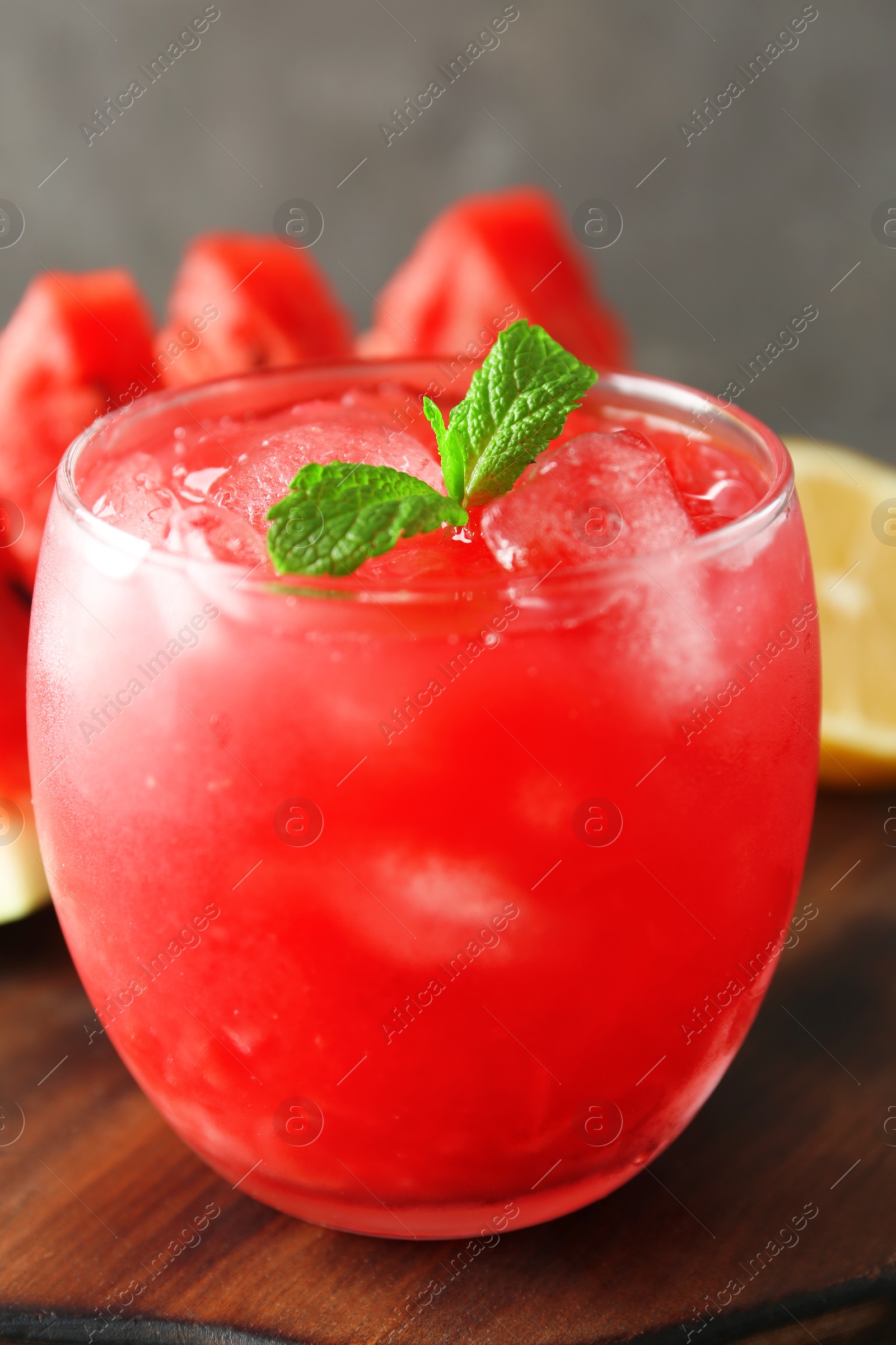 Photo of Tasty watermelon drink in glass on wooden table, closeup