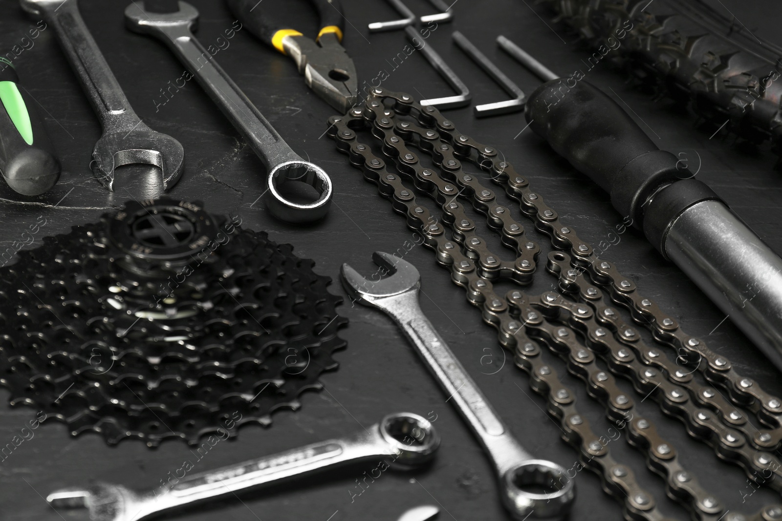 Photo of Parts of bicycle and tools on black table