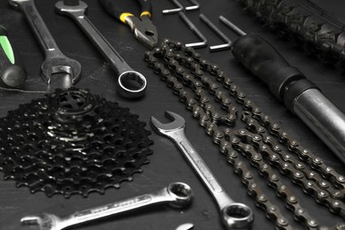 Parts of bicycle and tools on black table