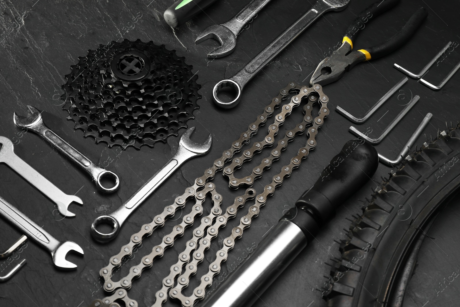 Photo of Parts of bicycle and tools on black table