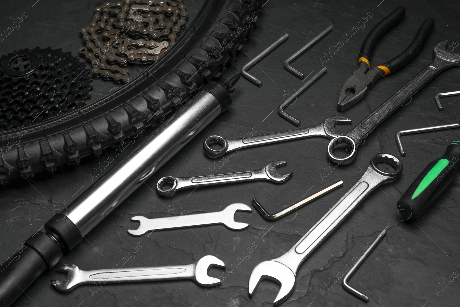 Photo of Parts of bicycle and tools on black table