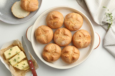 Photo of Flat lay composition with homemade tasty buns and butter on white table