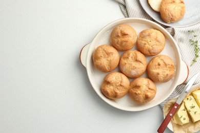 Photo of Flat lay composition with homemade tasty buns and butter on white table. Space for text