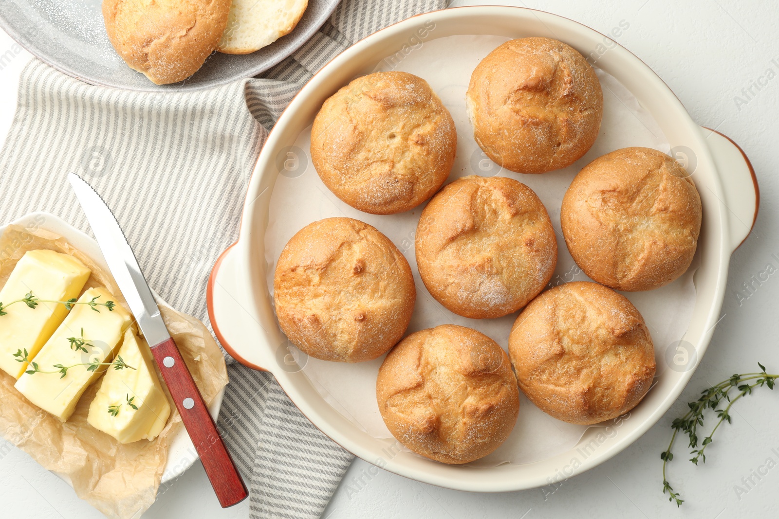 Photo of Flat lay composition with homemade tasty buns and butter on white table