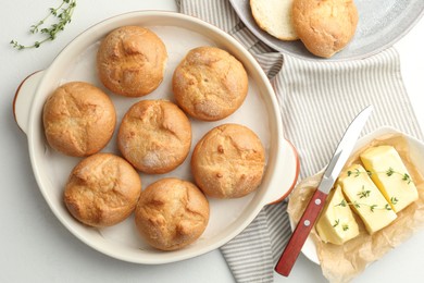 Flat lay composition with homemade tasty buns and butter on white table