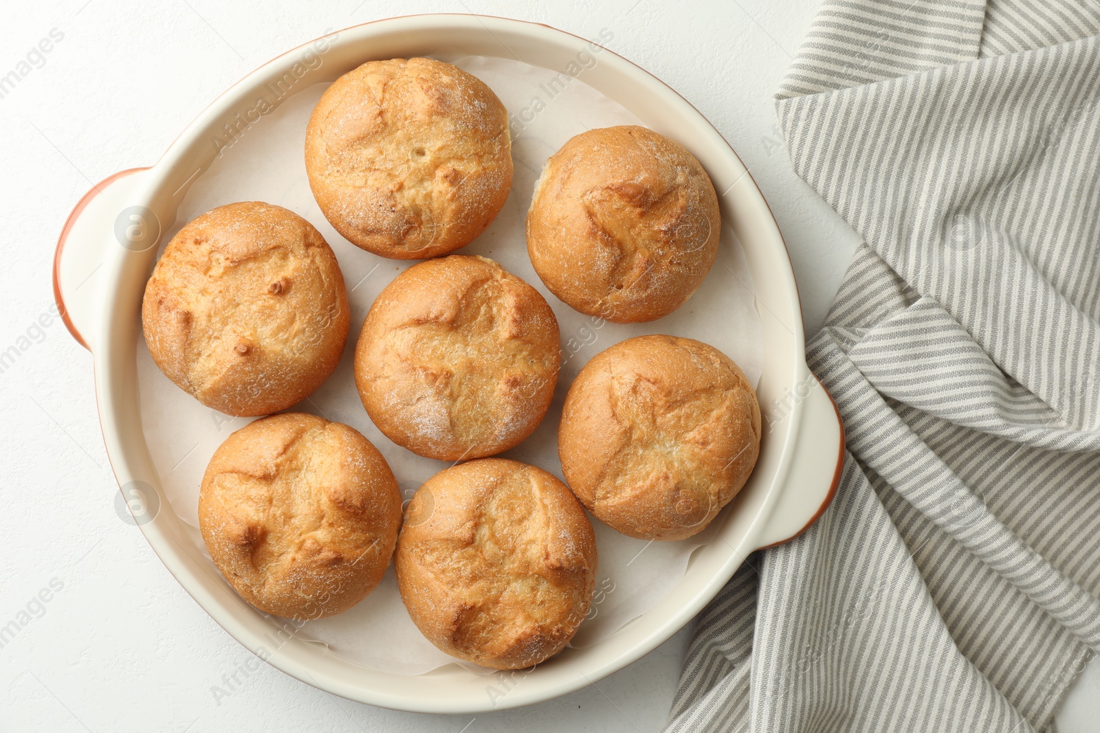 Photo of Baking dish with homemade tasty buns on white table, top view