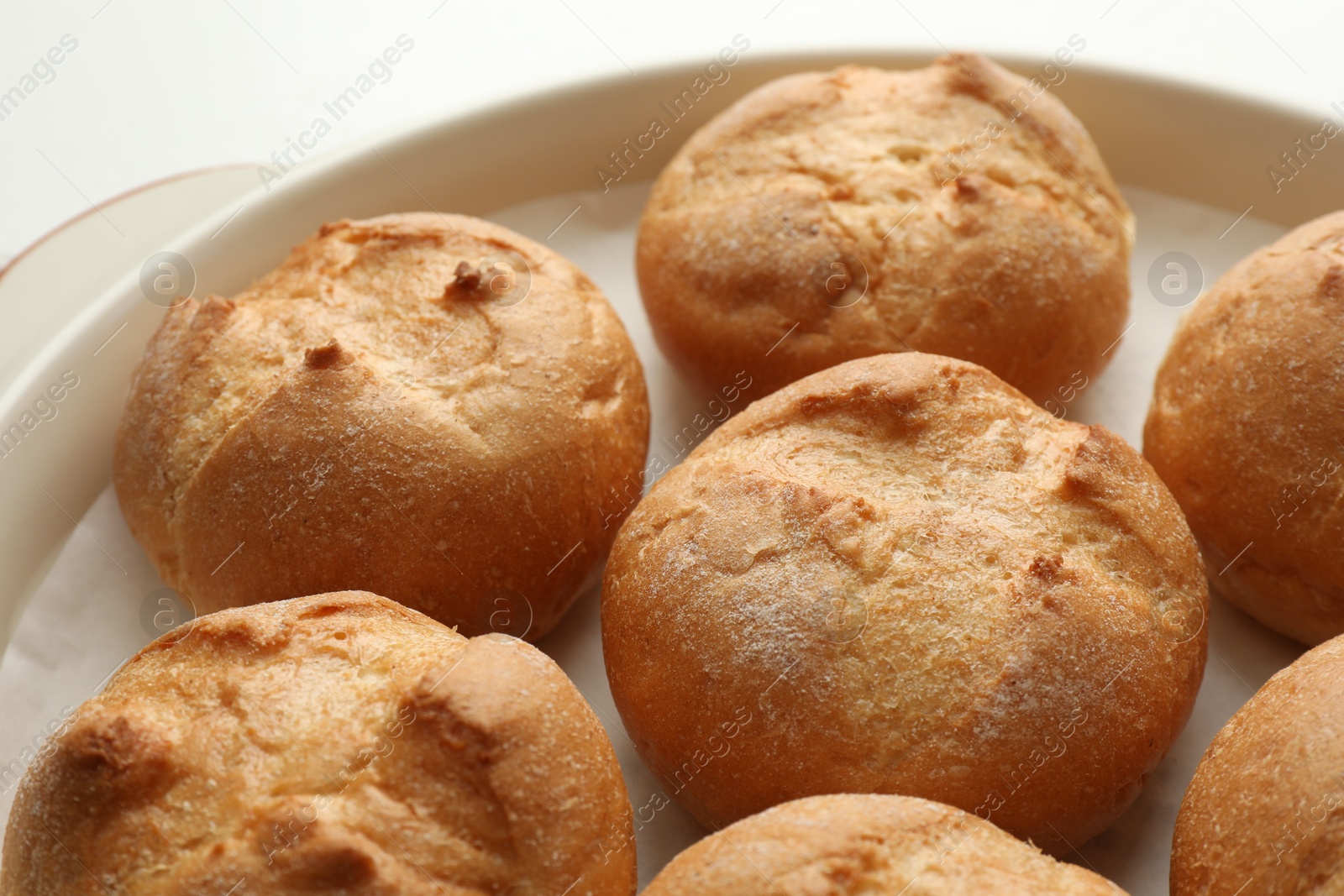 Photo of Homemade tasty buns in baking dish, closeup