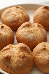 Photo of Homemade tasty buns in baking dish, closeup