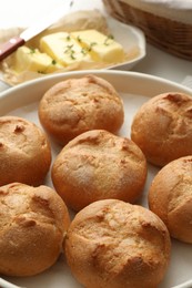 Photo of Baking dish with homemade tasty buns on table, closeup