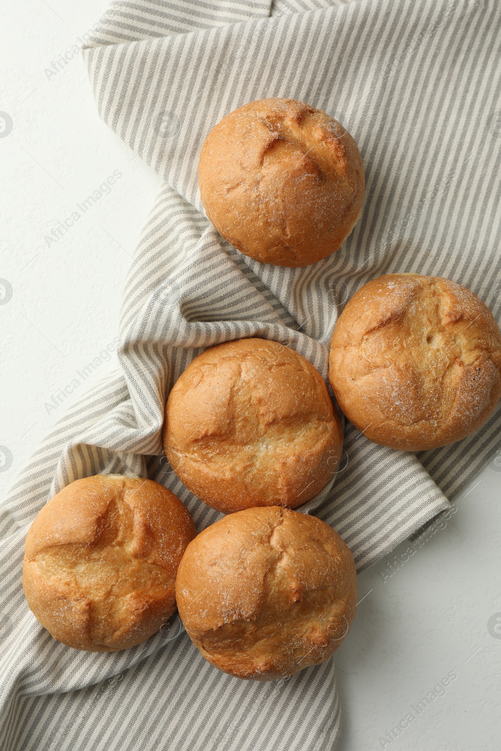 Photo of Homemade tasty buns on light table, top view