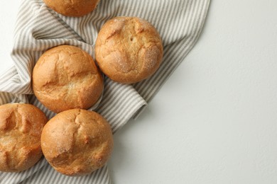 Homemade tasty buns on light table, top view. Space for text