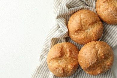 Homemade tasty buns on light table, top view. Space for text