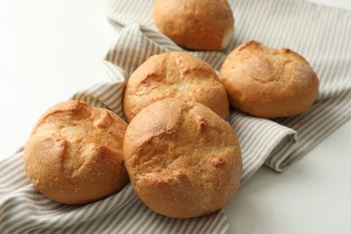 Photo of Homemade tasty buns on light table, closeup