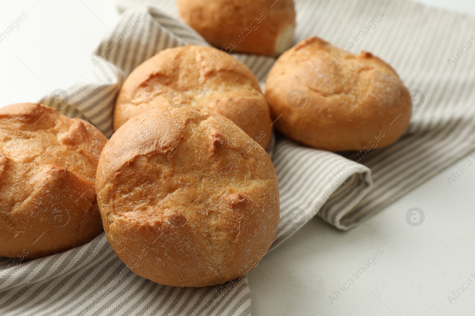 Photo of Homemade tasty buns on light table, closeup