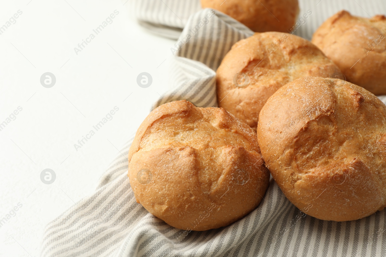 Photo of Homemade tasty buns on light table, closeup. Space for text