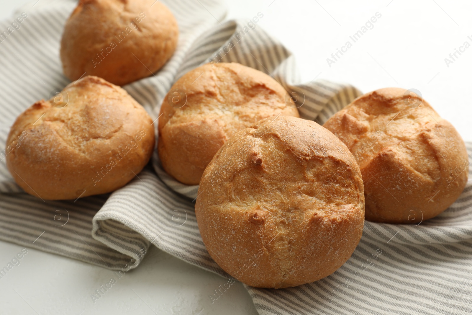 Photo of Homemade tasty buns on light table, closeup