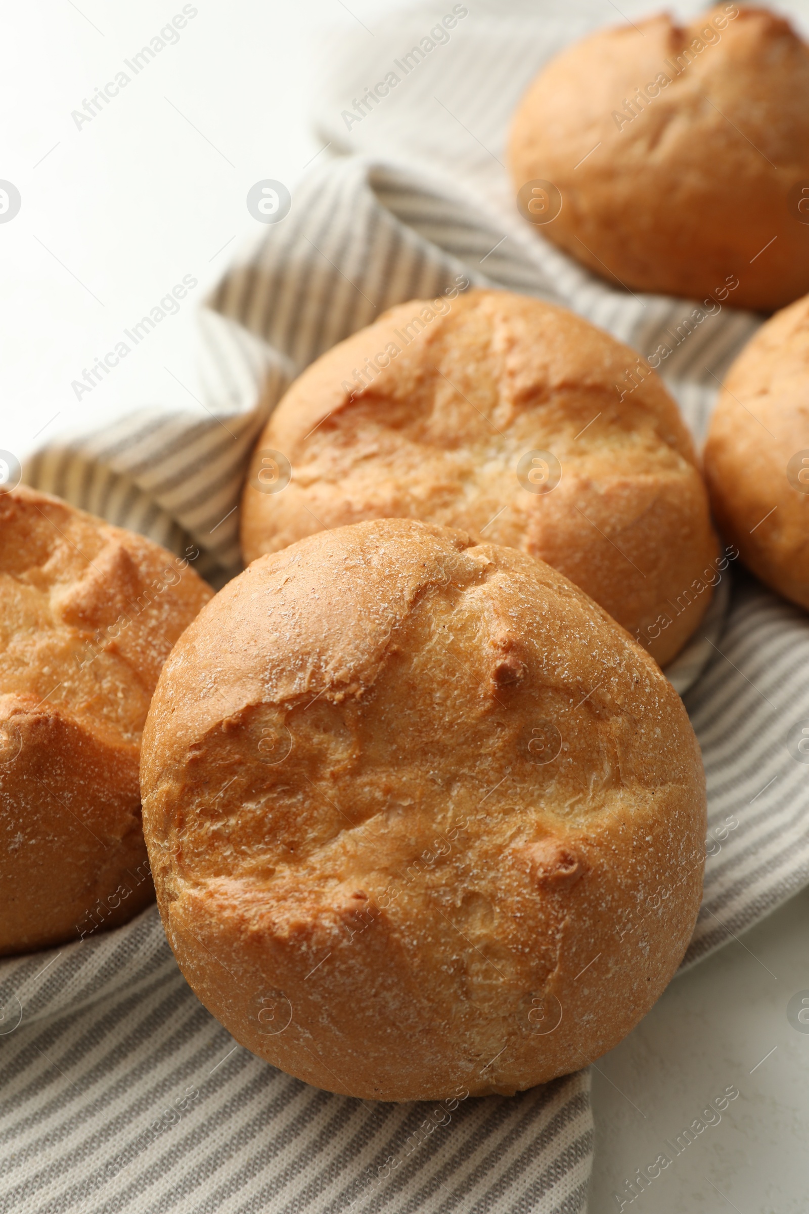 Photo of Homemade tasty buns on light table, closeup