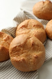 Photo of Homemade tasty buns on light table, closeup