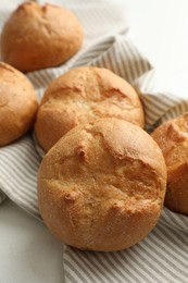 Photo of Homemade tasty buns on light table, closeup