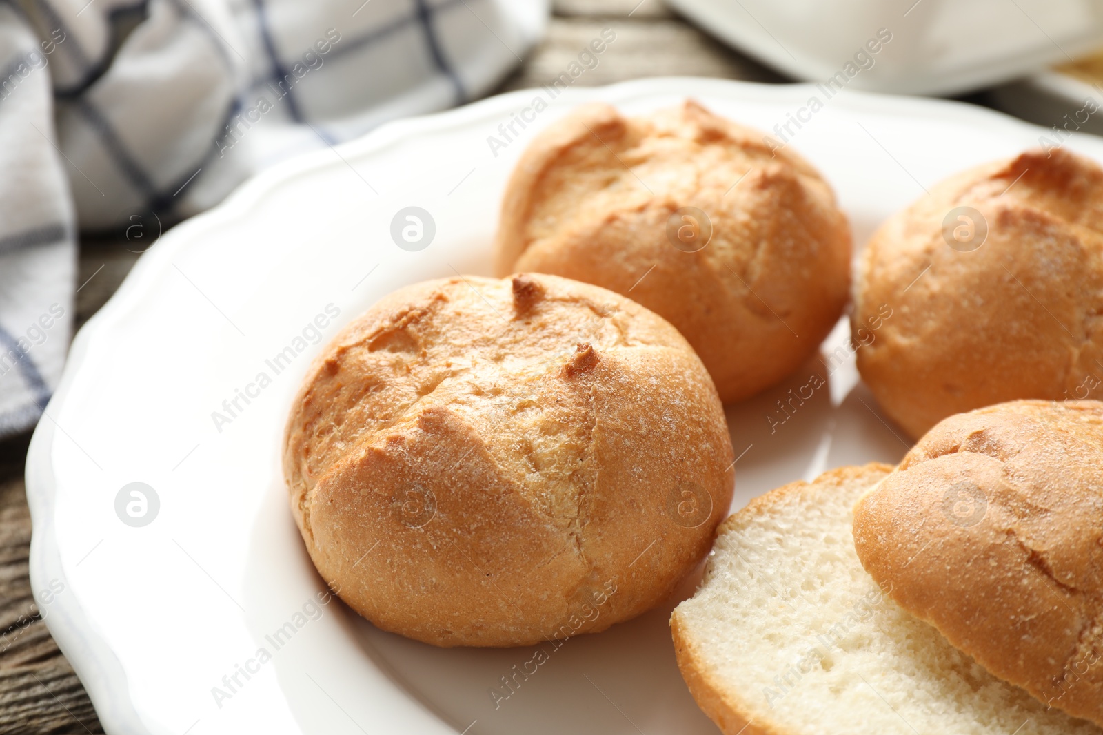 Photo of Plate with homemade tasty buns on table, closeup