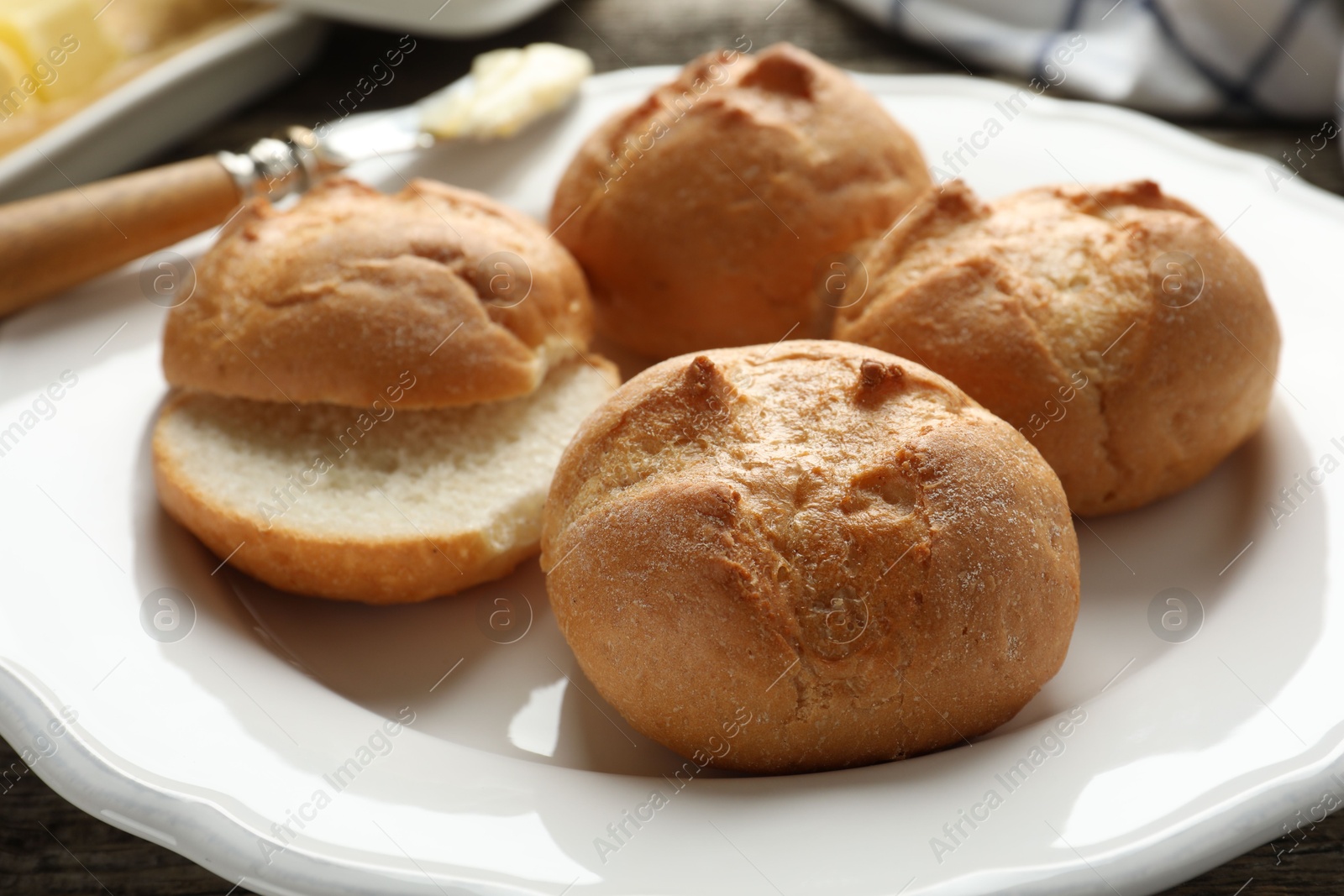 Photo of Plate with homemade tasty buns on table, closeup